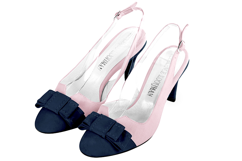 Navy blue and light pink open back shoes with a knot. Round toe. Medium slim heel